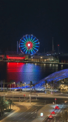 Illuminated Ferris wheel draws crowds in bustling Lusail nighttime