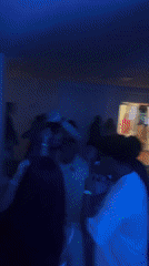 Dancing under colored lights at an indoor party