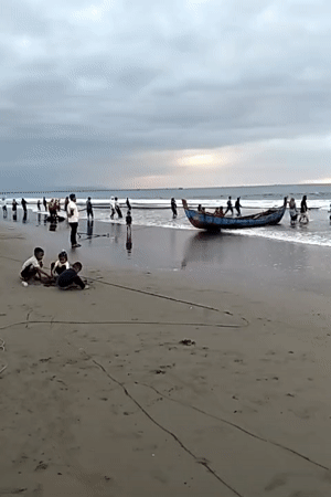 Net hauling and beachside play at dusk in Uleekareung