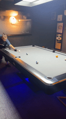 Man plays pool in early morning hours in Da Lat