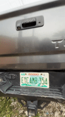 Street gathering observed near parked vehicles in Ado, Nigeria