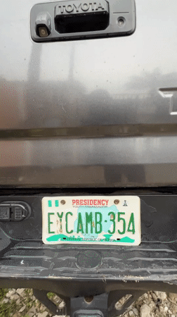 Street gathering observed near parked vehicles in Ado, Nigeria