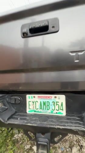 Street gathering observed near parked vehicles in Ado, Nigeria