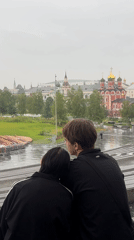 A quiet moment shared overlooking the Moscow cityscape.