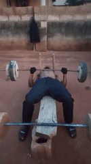 Man uses improvised gym equipment for outdoor workout in Bukuru