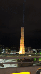 Illuminated tower projects blue-white beam into Tbilisi night sky