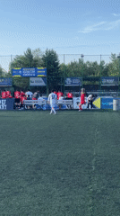 Soccer match between red and white teams in Astana