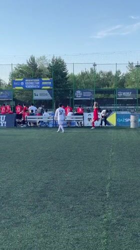 Soccer match between red and white teams in Astana