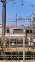 Morning commuter trains operate through Depok, Indonesia stations