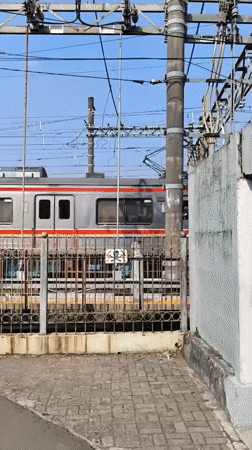 Morning commuter trains operate through Depok, Indonesia stations