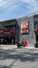Red plush figures spotted on North Kuta building balcony