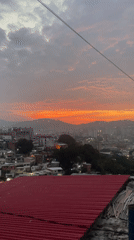Rooftop observer documents Caracas cityscape at dusk