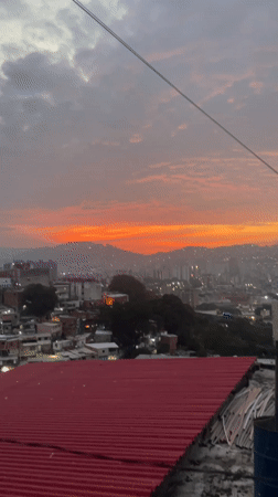 Rooftop observer documents Caracas cityscape at dusk