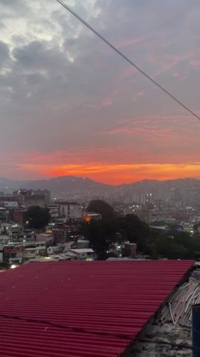 Rooftop observer documents Caracas cityscape at dusk