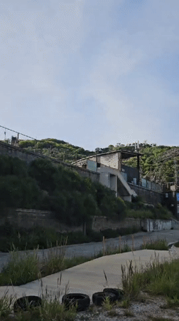 Building complex documented on Montenegro hillside amid cloudy skies