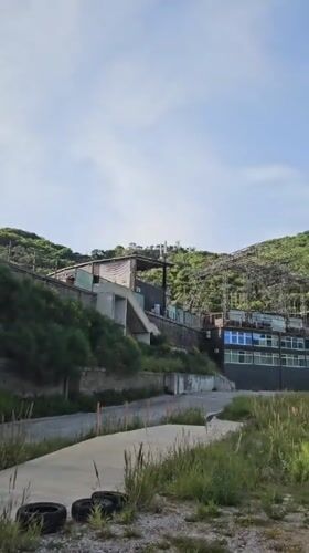 Building complex documented on Montenegro hillside amid cloudy skies
