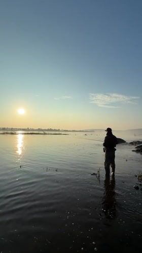 Dawn fishing session by waterfall in Chernushka, Russia