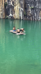 Three men spotted rafting on green quarry lake in Da Lat