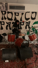 Musician plays drums in decorated Buenos Aires room