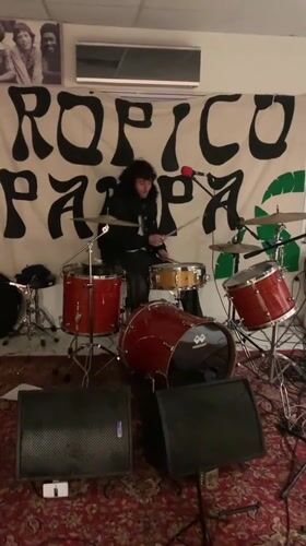 Musician plays drums in decorated Buenos Aires room