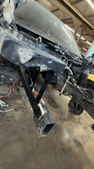 Auto repair shop activity with disassembled car and parked vehicles