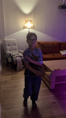 Boy dances in Minecraft shirt in Rostov living room