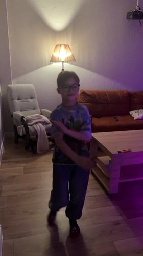 Boy dances in Minecraft shirt in Rostov living room