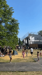 London park hosts afternoon music festival with crowds picnicking