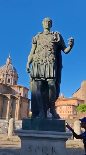 Roman emperor statue observed on SPQR pedestal in Rome