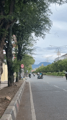 Morning traffic flows on tree-lined Banda Aceh street