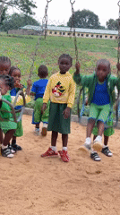 Children play on swings at Akwanga playground