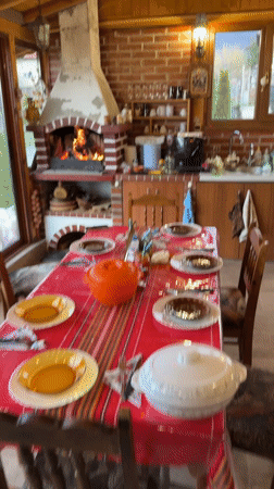 Cozy kitchen scene captured with lit fireplace and dining setup