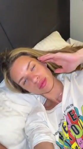 Person adjusts hair while lying on pillow in Berlin
