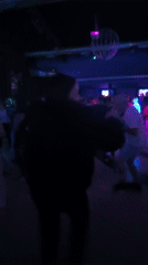 Person dances at crowded nightclub in Pontevedra, Spain