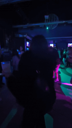 Person dances at crowded nightclub in Pontevedra, Spain