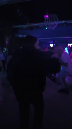 Person dances at crowded nightclub in Pontevedra, Spain