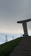 Visitors document sword monuments at Georgian hilltop memorial site