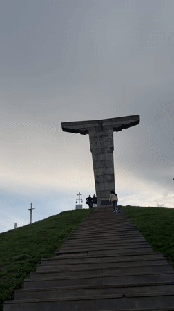 Visitors document sword monuments at Georgian hilltop memorial site