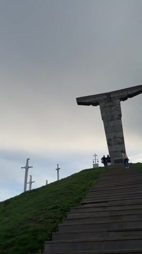 Visitors document sword monuments at Georgian hilltop memorial site