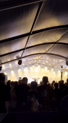 Tent concert and public art at an outdoor festival
