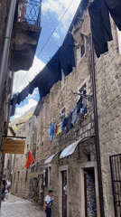 Tourist documents historic Kotor Old Town architecture and streetlife