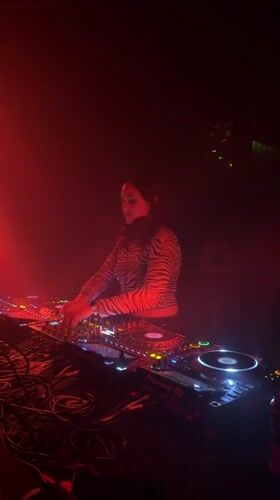 Early morning DJ set in red-lit Montreal venue