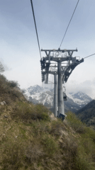 Cable cars operate against mountain backdrop in Almaty