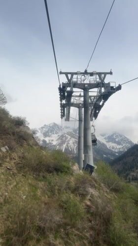 Cable cars operate against mountain backdrop in Almaty
