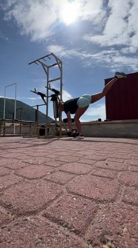 Woman exercises with dumbbells on Montenegro rooftop