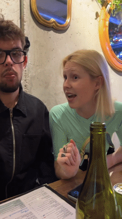 Three people gather at Paris restaurant table