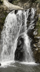 Waterfall flows over rocky terrain in Đà Nẵng, Vietnam