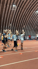 Exercise class in session on a red indoor track
