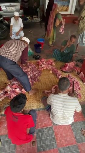 Early morning meat processing operation observed in Dhaka courtyard