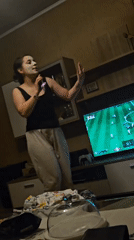 Woman dances at home while FIFA gaming streams captured